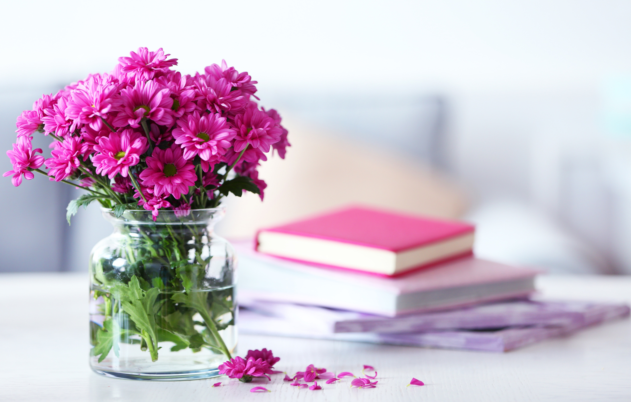 Flowers in Vase and Books on Table in Room