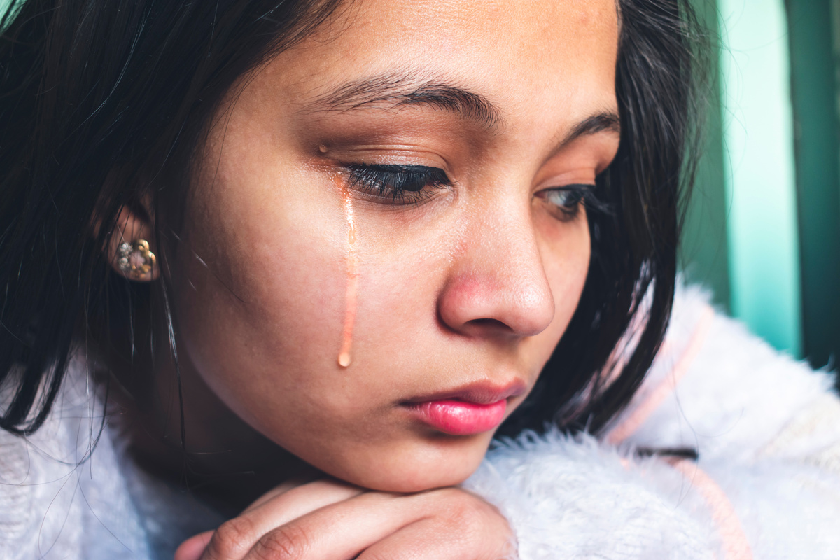 sad cute teenager girl is crying