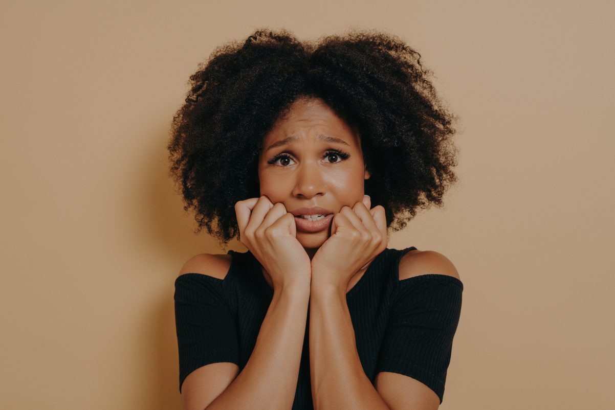 Scared mixed race female looking nervously and feeling stres